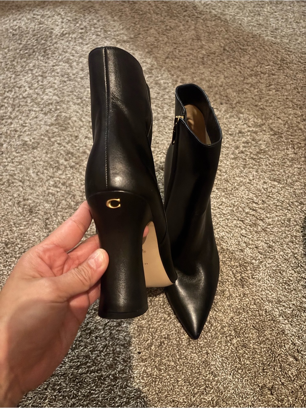 Coach Black Leather Pointed Toe Ankle Boots with Gold Accent